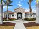 Community clubhouse entrance with archway and landscaping at 116 Daylily Blvd, Nokomis, FL 34275