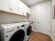 Bright laundry room with washer, dryer, and ample storage at 116 Daylily Blvd, Nokomis, FL 34275