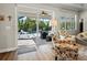 View of pool and patio from living room through sliding glass doors at 116 Daylily Blvd, Nokomis, FL 34275