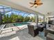 Relaxing pool area with covered patio and wicker furniture at 116 Daylily Blvd, Nokomis, FL 34275