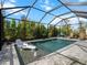 Inviting screened pool with water features and lounge chairs at 116 Daylily Blvd, Nokomis, FL 34275