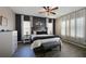 Main bedroom with a dark accent wall, and neutral bedding at 11924 Forest Park Cir, Bradenton, FL 34211