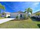 Tan one-story house with two-car garage and palm trees at 11924 Forest Park Cir, Lakewood Ranch, FL 34211