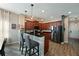 Modern kitchen with dark wood cabinets and an island breakfast bar at 11924 Forest Park Cir, Bradenton, FL 34211