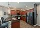 Modern kitchen with dark wood cabinets, granite countertops, and stainless steel appliances at 11924 Forest Park Cir, Lakewood Ranch, FL 34211