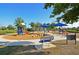 Community playground with slides, playsets, and shaded areas at 11924 Forest Park Cir, Lakewood Ranch, FL 34211