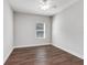 Simple bedroom with wood-look flooring and neutral walls at 12310 Halfmoon Lake Ter, Bradenton, FL 34211