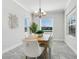 Elegant dining room with wood table, white chairs, and natural light at 12310 Halfmoon Lake Ter, Bradenton, FL 34211