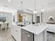 Kitchen island with white cabinets and a quartz countertop at 12310 Halfmoon Lake Ter, Bradenton, FL 34211