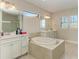 Elegant bathroom featuring a soaking tub and double vanity at 16446 Slate Pl, Bradenton, FL 34211