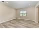 Spacious bedroom with wood-look floors and window at 16446 Slate Pl, Bradenton, FL 34211