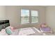 Bright bedroom with two windows and a comfortable bed at 16446 Slate Pl, Bradenton, FL 34211