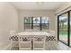 Bright dining room with table and chairs near sliding glass doors to pool at 16446 Slate Pl, Bradenton, FL 34211