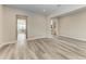 Bright hallway with wood-look floors leading to kitchen and stairs at 16446 Slate Pl, Bradenton, FL 34211