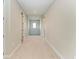 Long hallway with neutral walls and plush carpeting at 16446 Slate Pl, Bradenton, FL 34211