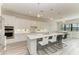 Modern kitchen featuring white cabinets, quartz island, and stainless steel appliances at 16446 Slate Pl, Bradenton, FL 34211