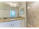 Bright bathroom boasts granite countertops, white cabinets, and a tiled shower at 16706 Vardon Ter # 205, Bradenton, FL 34211