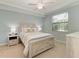 Bedroom with light wood platform bed, ceiling fan, and large window at 16706 Vardon Ter # 205, Bradenton, FL 34211