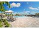 Relaxing poolside view with lounge chairs and umbrellas at 16706 Vardon Ter # 205, Bradenton, FL 34211