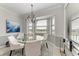 Elegant dining room featuring a glass-top table and chandelier at 16904 Vardon Ter # 405, Bradenton, FL 34211