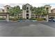 Condo building with palm trees and covered parking at 16904 Vardon Ter # 405, Bradenton, FL 34211