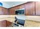 Modern kitchen with granite countertop and stainless steel appliances at 16904 Vardon Ter # 405, Bradenton, FL 34211