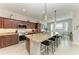 Island kitchen features granite countertops and breakfast bar at 16904 Vardon Ter # 405, Bradenton, FL 34211