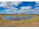 Aerial view of a community with a pond and palm trees at 1944 Vista Landings Ct, Port Charlotte, FL 33953