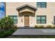 Tan building exterior with brown door and landscaping at 1944 Vista Landings Ct, Port Charlotte, FL 33953