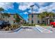 Tan three-story townhouses with parking and landscaping at 1944 Vista Landings Ct, Port Charlotte, FL 33953