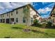 Townhouse exterior with grassy yard and landscaping at 1944 Vista Landings Ct, Port Charlotte, FL 33953