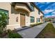 Building exterior showcasing a brown door and walkway at 1944 Vista Landings Ct, Port Charlotte, FL 33953