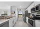 Modern kitchen with white cabinets, stainless steel appliances, and granite countertops at 1944 Vista Landings Ct, Port Charlotte, FL 33953