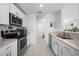 Modern kitchen with white cabinets, stainless steel appliances, and granite countertops at 1944 Vista Landings Ct, Port Charlotte, FL 33953