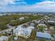 Aerial view highlighting a two-story house nestled in a neighborhood with lush greenery at 220 82Nd St, Holmes Beach, FL 34217