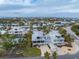 Aerial view of a two-story house with a large yard and ocean views at 220 82Nd St, Holmes Beach, FL 34217