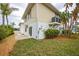 Landscaped backyard with patio and exterior access at 220 82Nd St, Holmes Beach, FL 34217