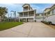 Two-story house with balcony, two-car garage, and driveway at 220 82Nd St, Holmes Beach, FL 34217