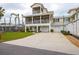 Two-story house with a large driveway and a screened porch at 220 82Nd St, Holmes Beach, FL 34217