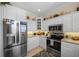 Bright kitchen featuring stainless steel appliances and white cabinets at 220 82Nd St, Holmes Beach, FL 34217