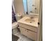 Compact bathroom with a small vanity, mirror, and toilet, providing essential amenities at 22389 Elmira Blvd, Port Charlotte, FL 33952