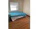 Bedroom showcasing hardwood floors, neutral walls, and a window for natural light at 22389 Elmira Blvd, Port Charlotte, FL 33952