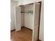 Empty closet with bi-fold doors and hardwood floors at 22389 Elmira Blvd, Port Charlotte, FL 33952