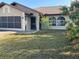 Charming single-story home features a neutral-toned exterior, attached garage, and well-maintained landscaping at 22389 Elmira Blvd, Port Charlotte, FL 33952