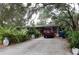 House with a long driveway and mature landscaping at 2311 Roselawn Cir, Sarasota, FL 34231