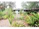 Ranch home with lush landscaping and mature plants at 2311 Roselawn Cir, Sarasota, FL 34231