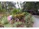 Landscaped front yard with colorful plants and a unique mailbox at 2311 Roselawn Cir, Sarasota, FL 34231