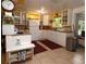 Kitchen with white cabinets and a red patterned rug at 2311 Roselawn Cir, Sarasota, FL 34231