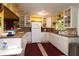 White kitchen with glass-front cabinets and yellow walls at 2311 Roselawn Cir, Sarasota, FL 34231