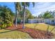 Landscaped backyard with shed and playset at 2329 Outer Dr, Sarasota, FL 34231